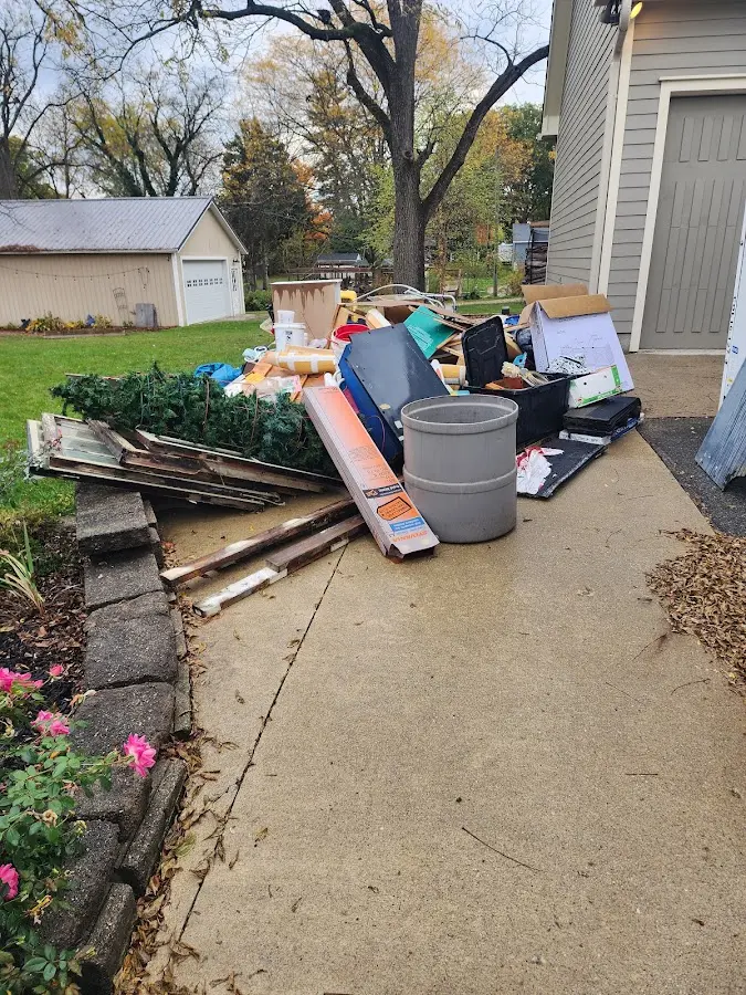 Dumpster being loaded with debris for Roofing Dumpster Rental in Fallbrook